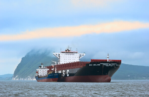 Nakhodka, Russia-22.07.2015: Bunkering tanker Vitaly Vanukhin container ship MSC company. Nakhodka Bay. East (Japan) Sea. 22.07.2015