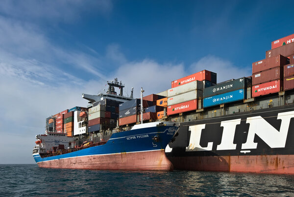 Nakhodka, Russia- 17.09.2015: Bunkering tanker Ostrov Russkiy container ship NYK Aphrodite. Nakhodka Bay. East (Japan) Sea. 17.09.2015