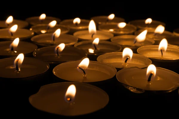 Small candles isolated on dark background — Stock Photo, Image