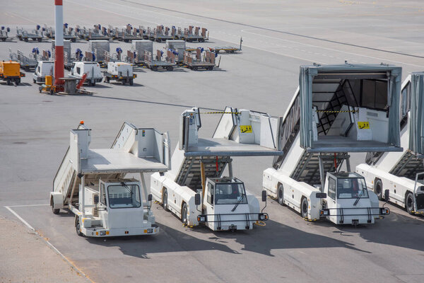 Passenger ladder stairs lined up in the parking lot airport