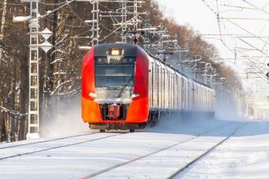 Express train passing snow covered winter landscape