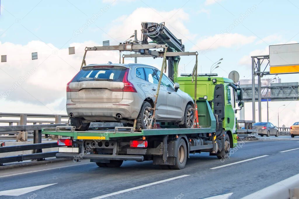 Hatchback car loaded onto a tow truck ready for transport