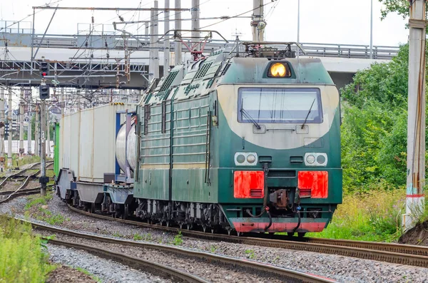 The freight train passes by the station. Wagons with goods delivery