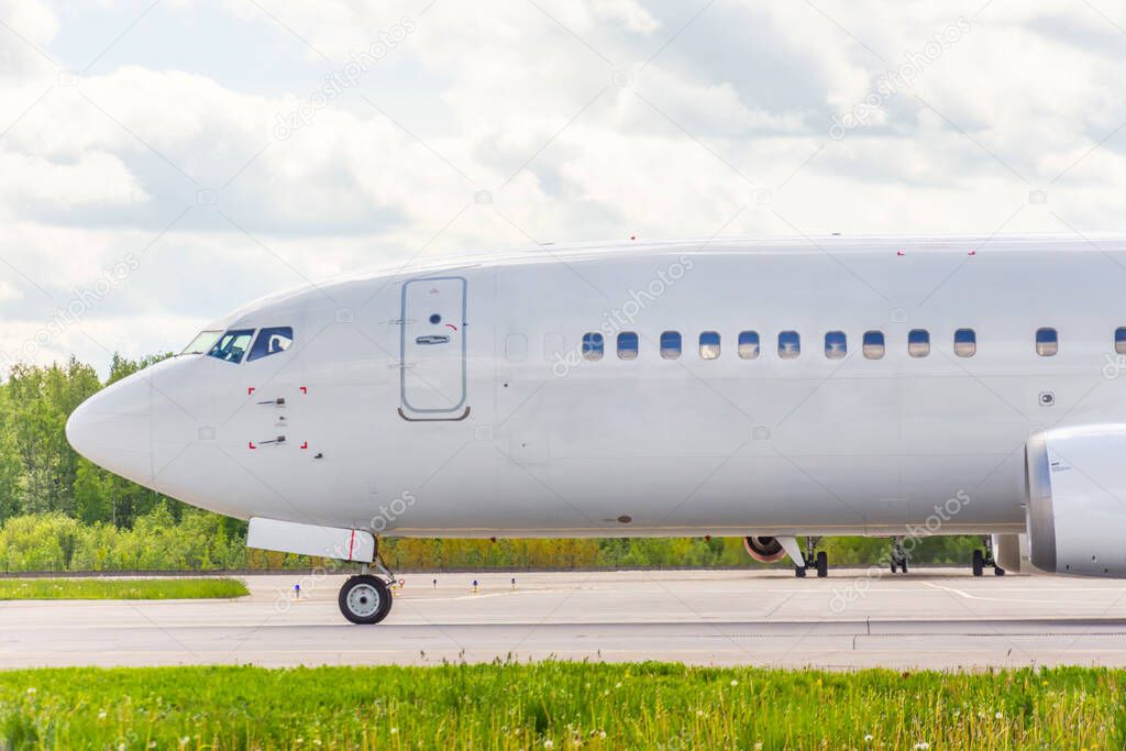 Side view of the aircraft cockpit, front landing gear, portholes, taxiing