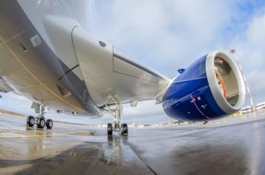 Plane parked next to the passenger terminal before the departure of the flight