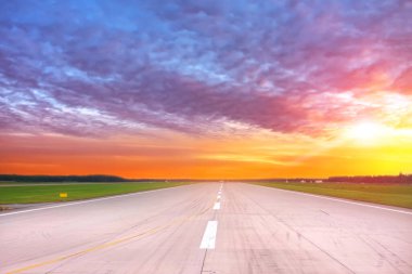 Empty runway with evening dawn sunset bright sky