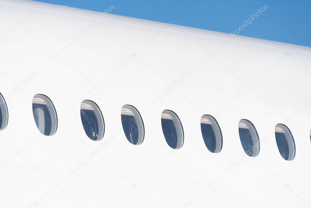 Windows on a white aircraft fuselage outdoor