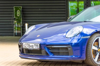 Porsche mavisi araba, yüksek şarj teknolojisiyle yükleniyor. Rusya, Saint-Petersburg, 27 Mayıs 2021