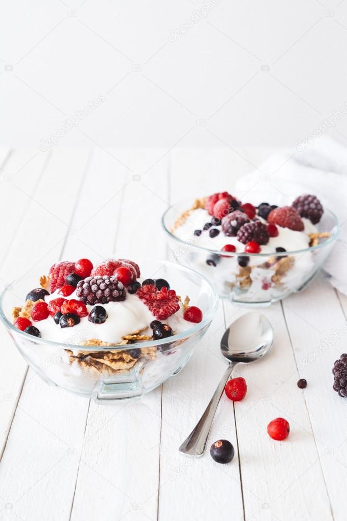 Granola with yogurt, strawberries, blackberries and blueberries