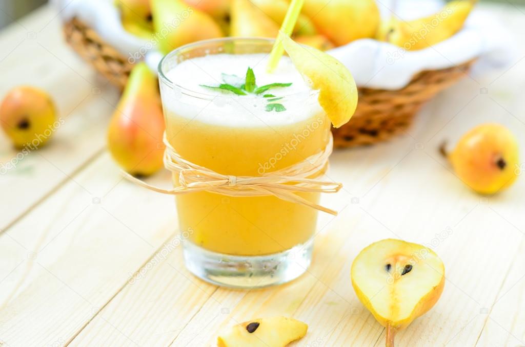 Pear Juice with fresh fruits on wooden boards