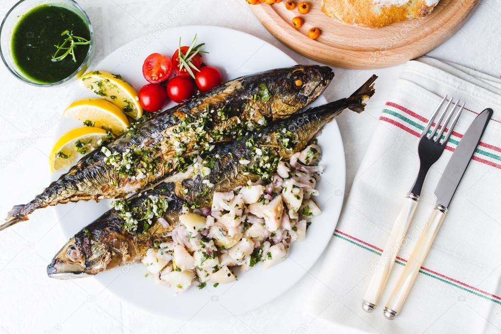Roasted whole mackerel fish stuffed with vegetables and almonds 