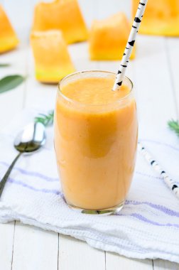 Glass of fresh cantaloupe smoothie