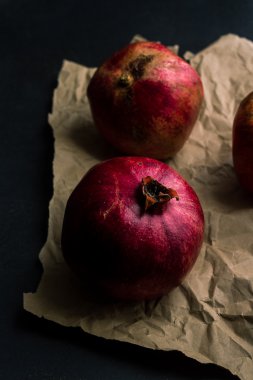 Whole pomegranates on a wooden table