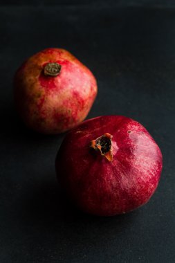 Whole pomegranates on a wooden table