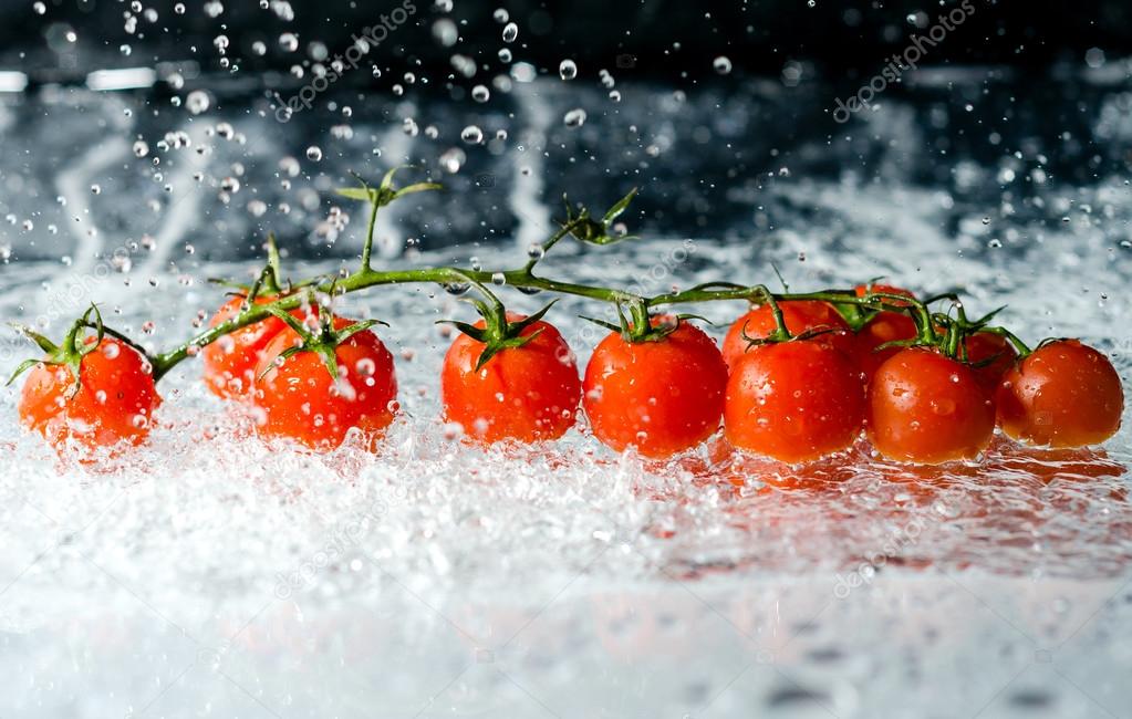 Cherry tomatoes in water splash