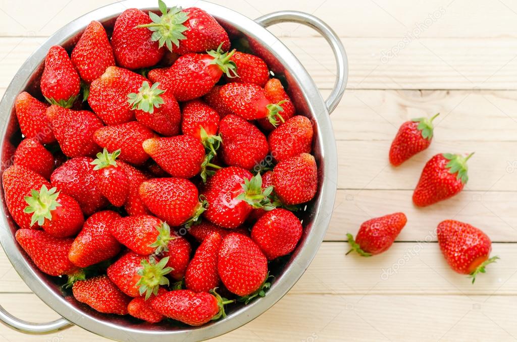 Fresh strawberries in retro colander