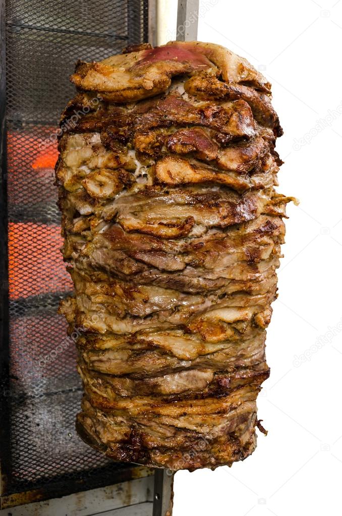Traditional fresh Greek Gyros meat on a stick. Isolated on white