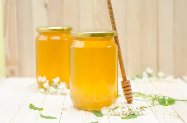 Two Locust Honey Jars with blossoms — Stock fotografie