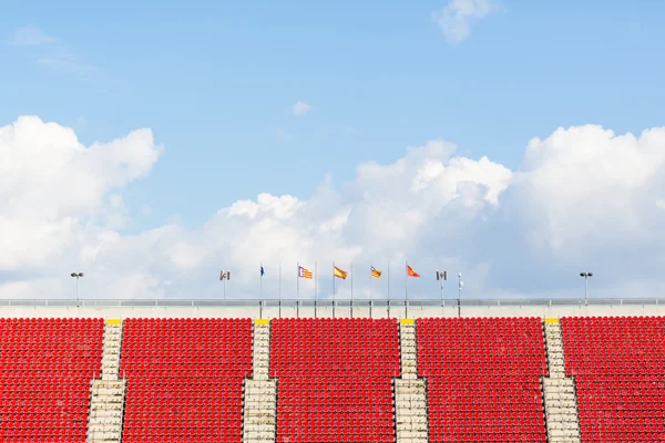 Empty seats in  a football stadium with spanish and european flaggs — Stock Photo, Image
