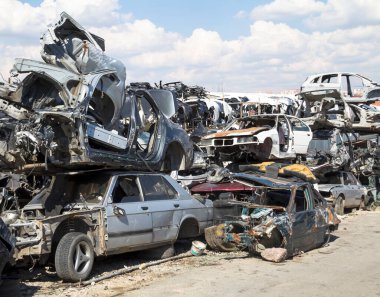 Car bodies stacked at the junkyard clipart