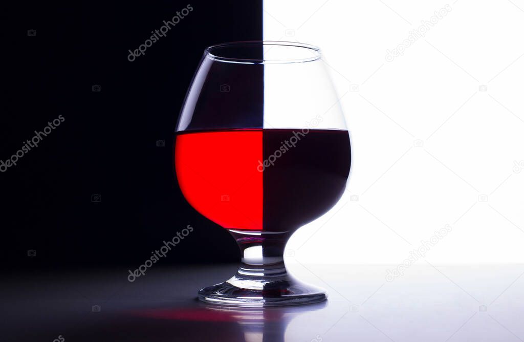 A glass of wine on an abstract background with a tilt effect.A photo taken at home. Moscow. Russia, wine, reflection, background. Summer of 2021. 