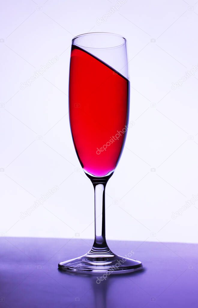 A glass of wine on an abstract background with a tilt effect.A photo taken at home. Moscow. Russia, wine, reflection, background. Summer of 2021. 