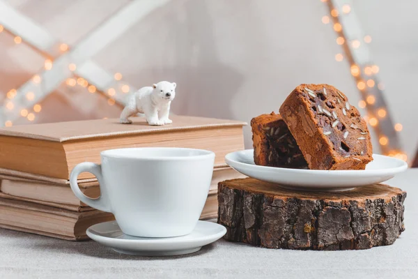 Composition books, polar bear, chocolate cake and cup of coffee on light background — Stock Photo, Image