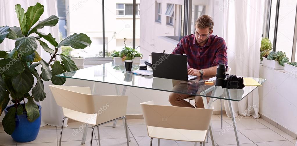 Businessman busy working from his desk at home