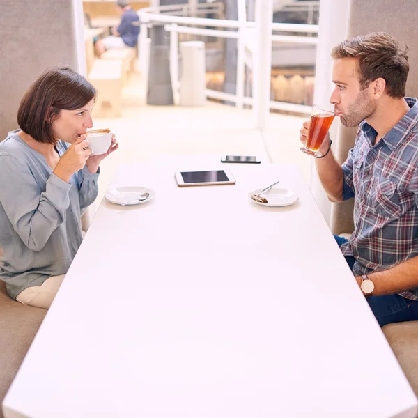 Nervous couple taking a sip on their first date — Stock Photo, Image