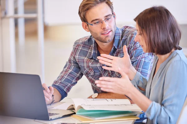 Man paying attention to his female business counterpart while working