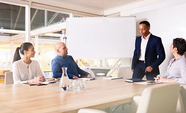 Chairman of company taking seat on table — Stock Photo, Image