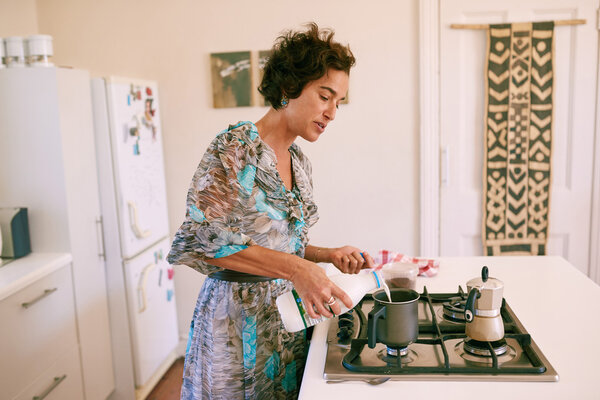 Mature woman preparing coffee in her kitchen