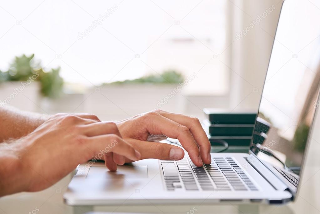 hands busy typing on a notebook with copy space