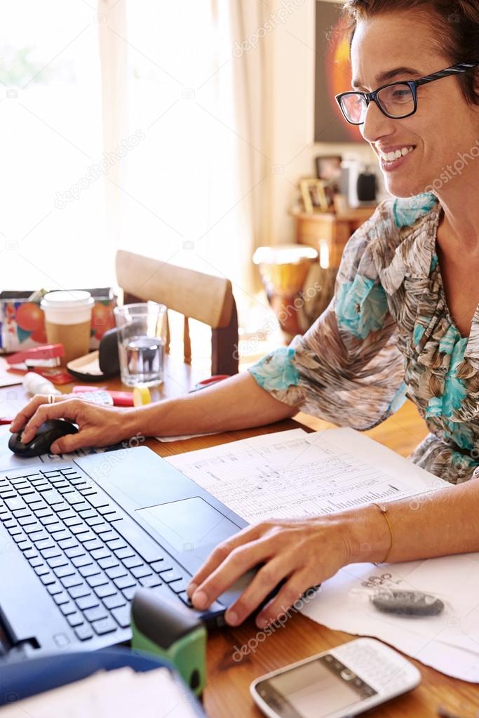 Mature self employed woman working from her home office
