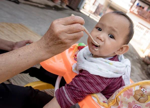 Baby eating food by spoon