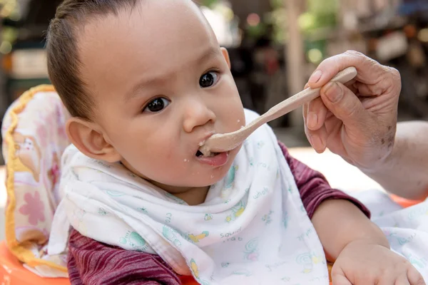 Bebê comendo comida por colher — Fotografia de Stock