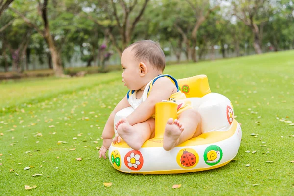 Outdoor portrait of Asian baby boy playing sitting and crawling — Stock Photo, Image