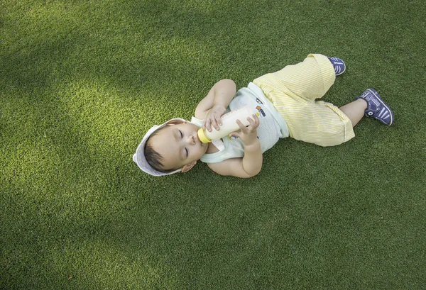 Baby drinking milk ,out door scene — Stock Photo, Image