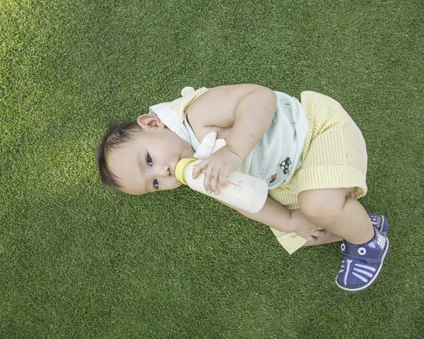 Baby drinking milk ,out door scene — Stock Photo, Image