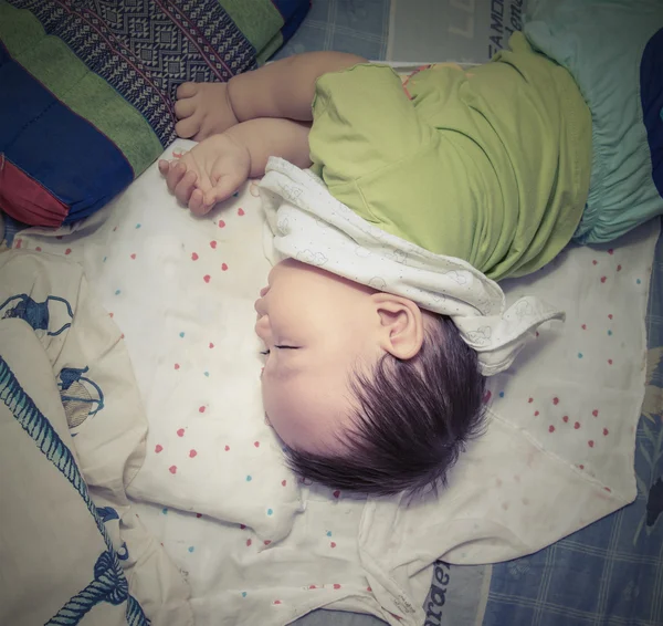 Asian Baby sleeping alone on the bed, Thai culture — Stock Photo, Image