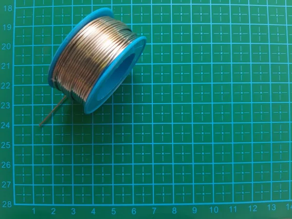solder wire on cutting mat background