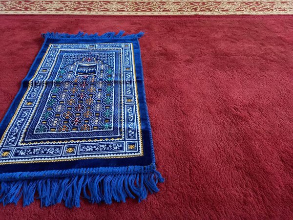 carpet with a book and a red star on a blue background