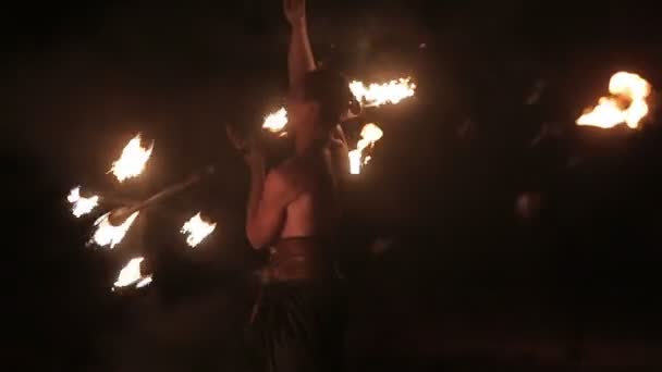 Fire show performance. Handsome male fire performer twirling fire baton with several wicks - dragon staff. Close-up. Slow motion — Stock Video