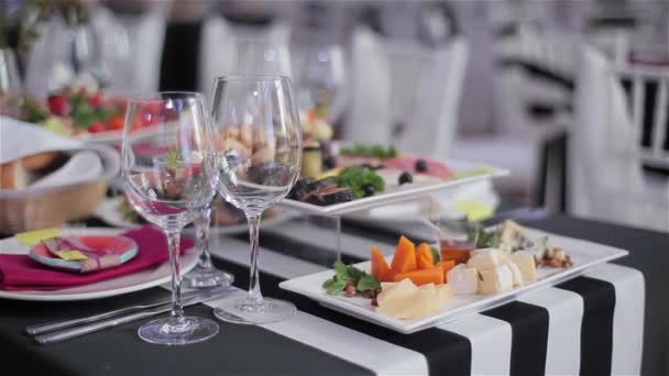 Served table in the restaurant with delicious snacks and appetisers. Close-up — Stock Video