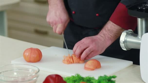 Gros plan des mains du chef coupant les tomates pelées — Video