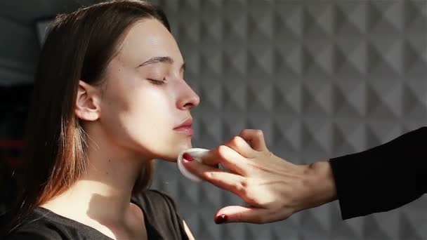 Make-up artist reinigen gezicht van model gebruiken katoen kussentjes om te verwijderen make-up. Huid zorg reiniging en bescherming. Close-up — Stockvideo