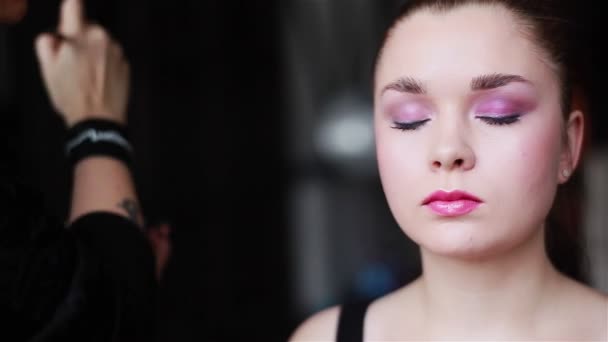 Professional make-up artist applying eyeshadow using a brush. Prepare for shooting. Close-up — Stock Video