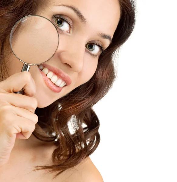 Young beauty showing her perfect skin with magnifying glass. — Stock Photo, Image