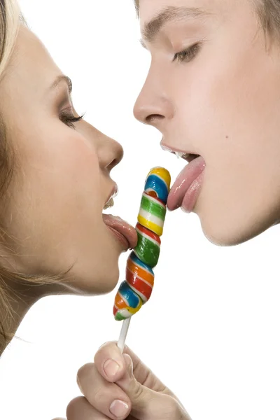 Happy Young Couple Licking a Lollipop — Stock Photo, Image