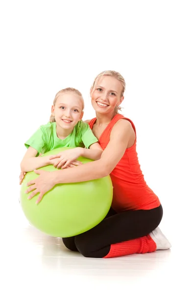 Little girl doing exercise with an instructor — Stock Photo, Image